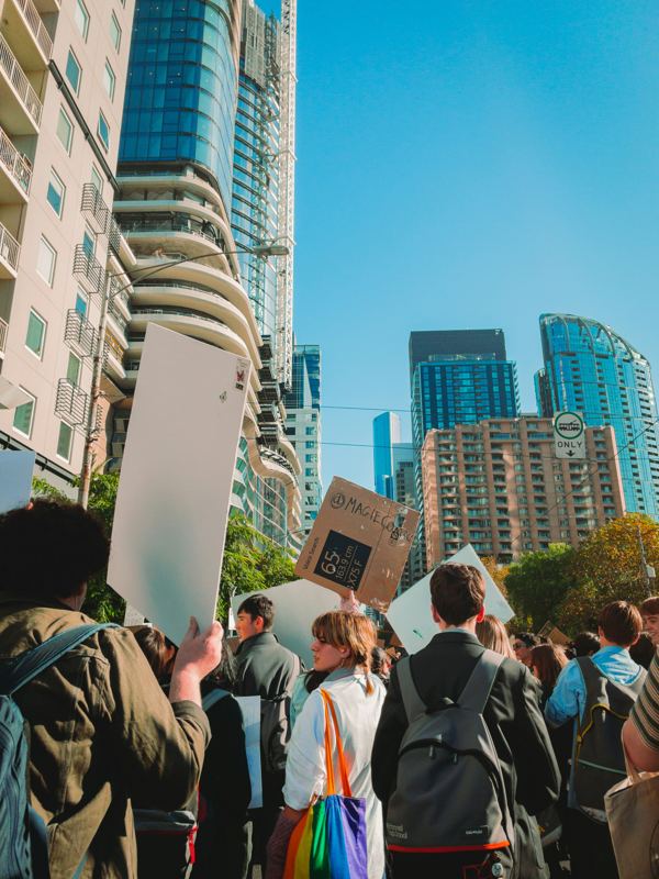 Climate campaigners marching with placards through a city centre
